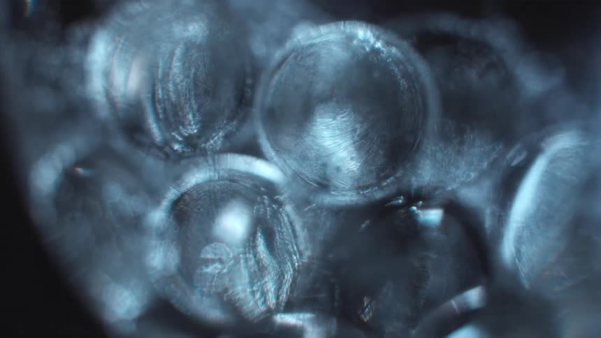 Light shines on clear spheres as they float and move