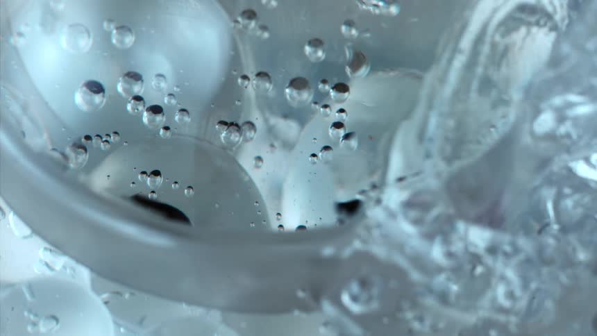 Water churns and bubbles as more water is added on top of ice spheres
