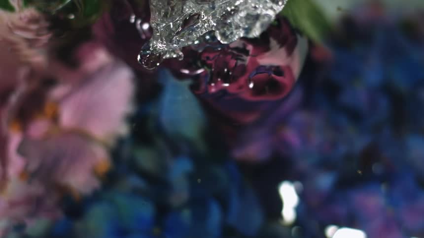 Water splashing over a colorful background