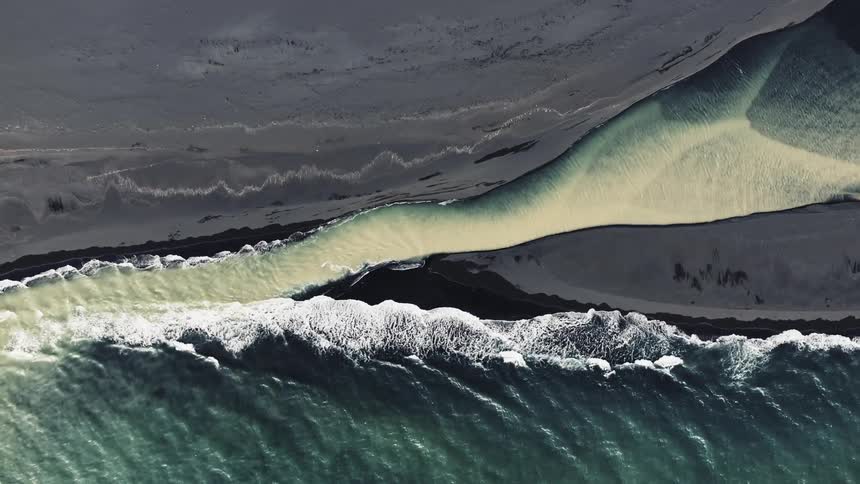 Colorful blue and yellow river with ocean shoreline