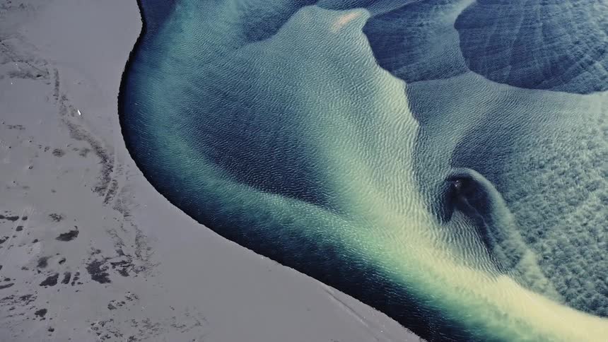 Aerial view of a river with blue and yellow water