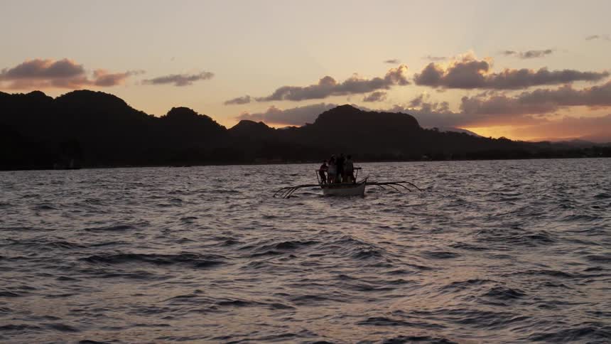 Raft-like craft on the waters at sunset