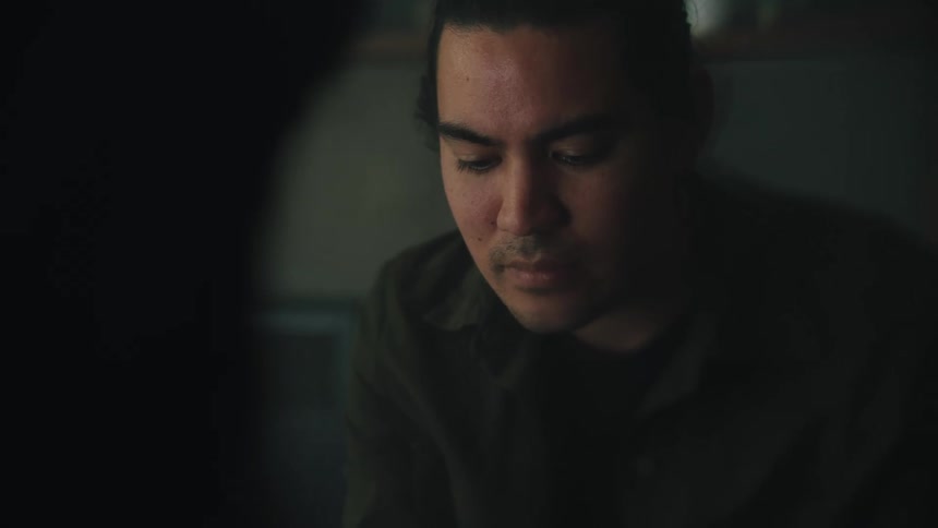 Light shines on a mans face as he looks down