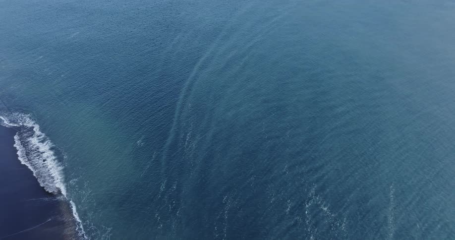 The ocean is hit by multiple waves