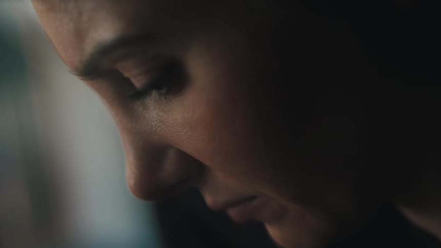 Closeup of a womans face looking down