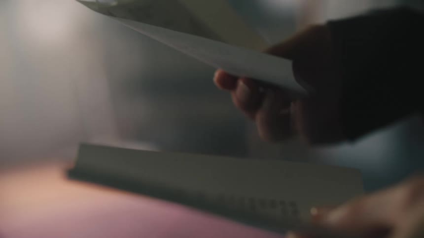 Closeup of a womans hands checking small invoices