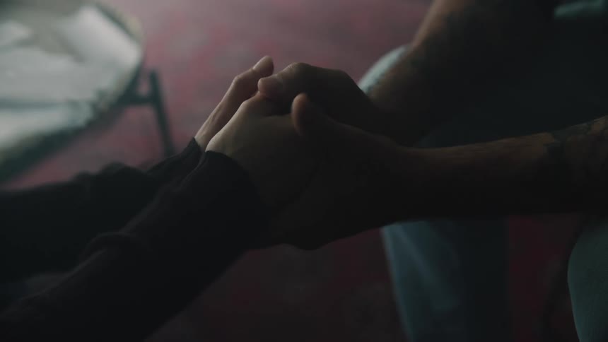 Hands clasped caressing each other