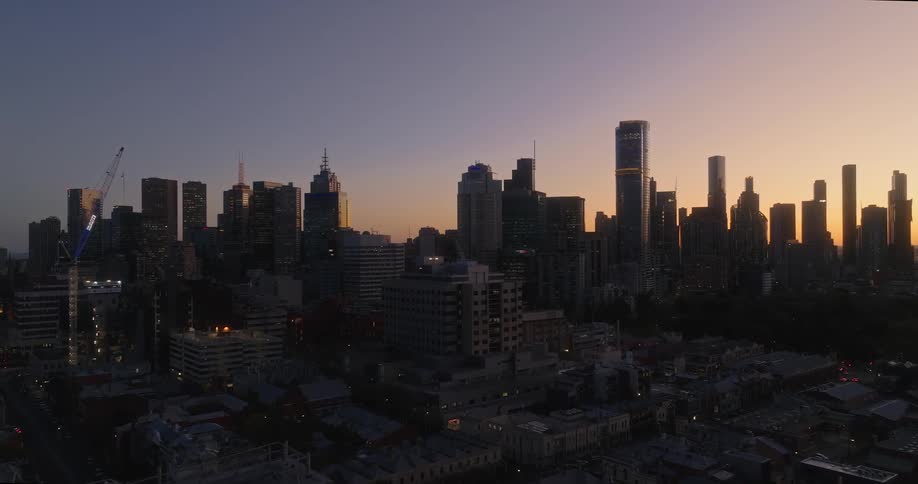 Aerial view of a metropolis skyline during sunrise