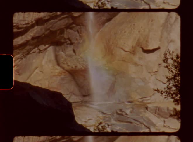 A waterfall falling from the rock in the forest during the day