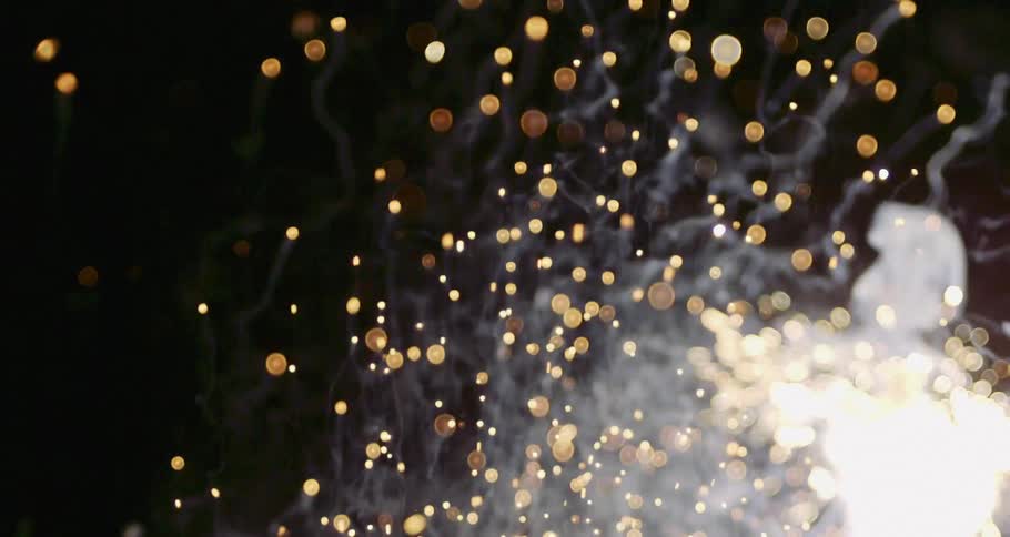 The fireworks explode giving off smoke