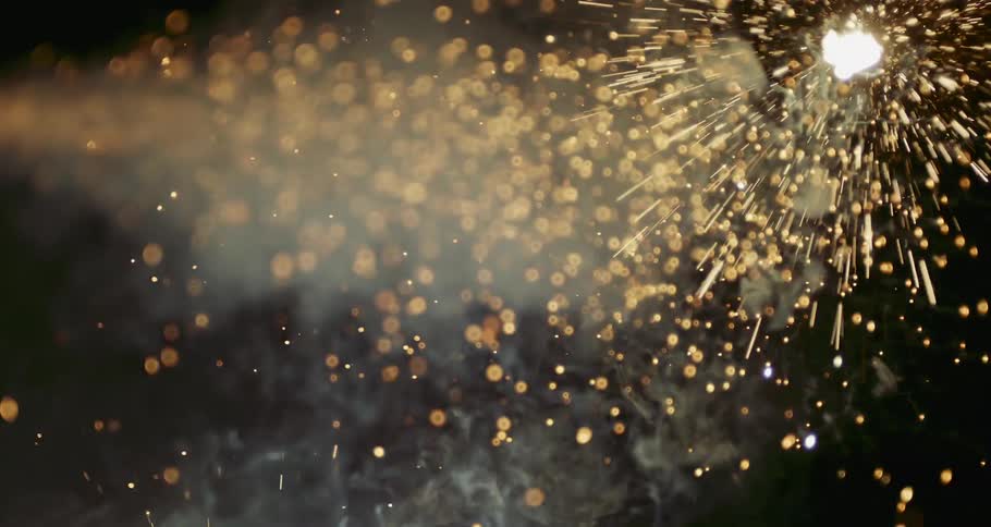 A stream of gold particles flowing across the darkness