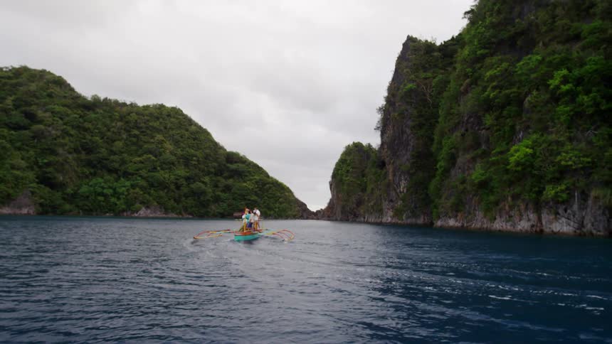 People ride on a boat down the river