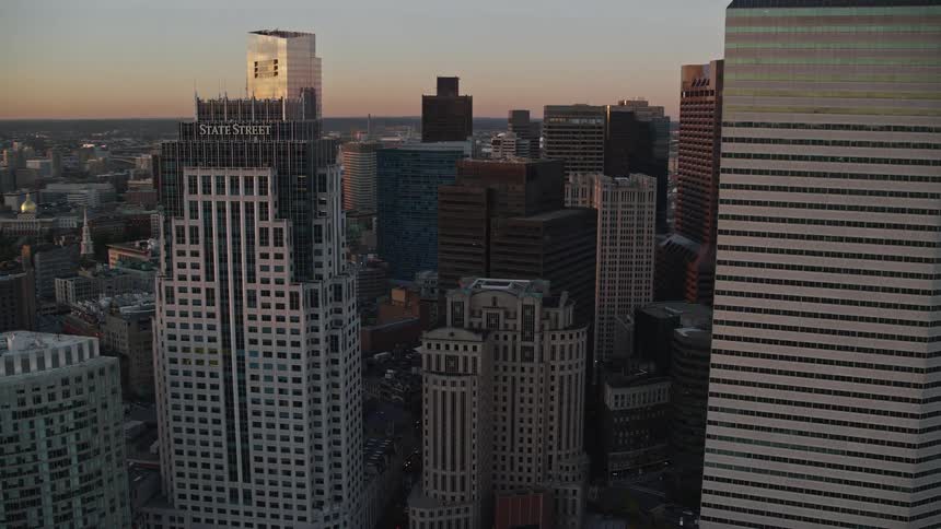 An aerial view shows skyscrapers in the citys downtown area during sunset