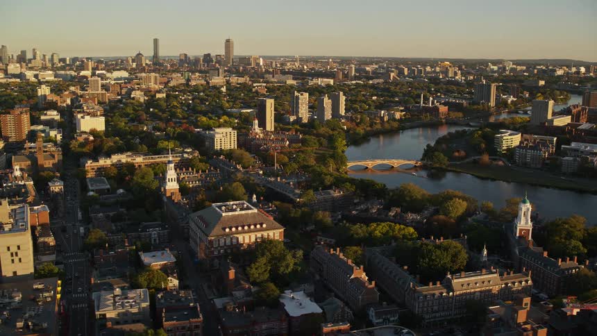 Aerial panorama of a city by a lake with the morning sun