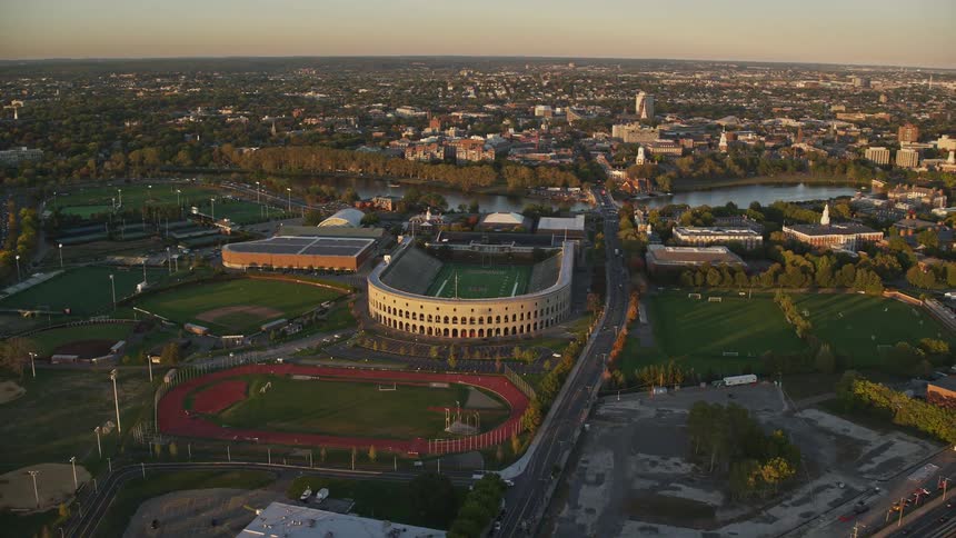 Aerial panorama of stadiums within a city and by the edge of a lake