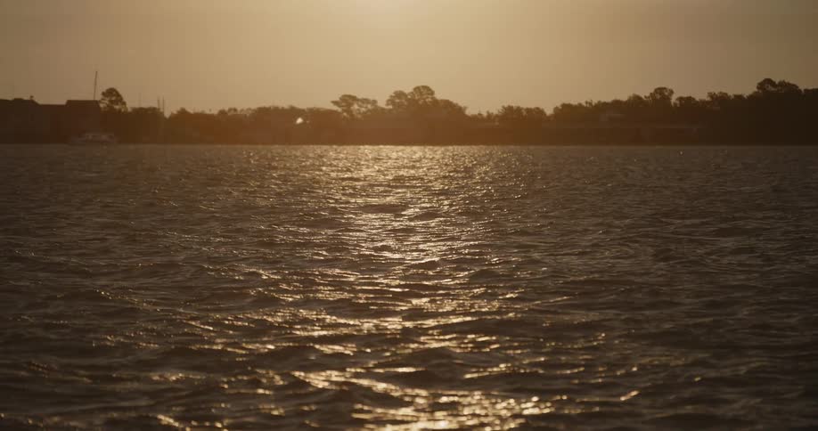 View of the sea with calm waves and a sunrise sky in slow motion