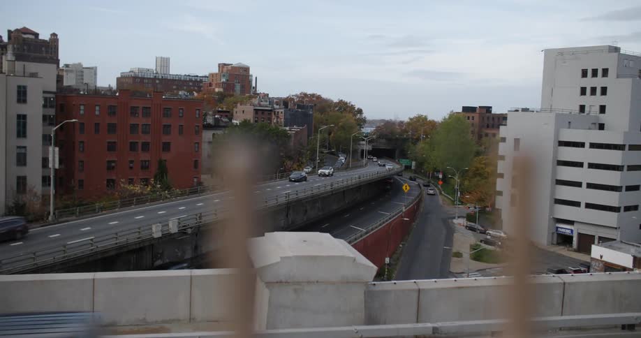 The cars drive on the freeway through the city