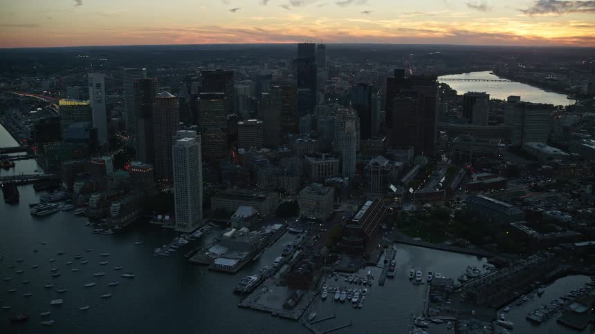 An aerial view of a metropolitan region with tall buildings facing the sea
