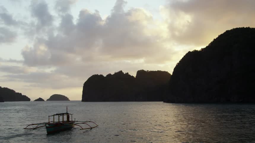Person sits on a fishing boat in the water