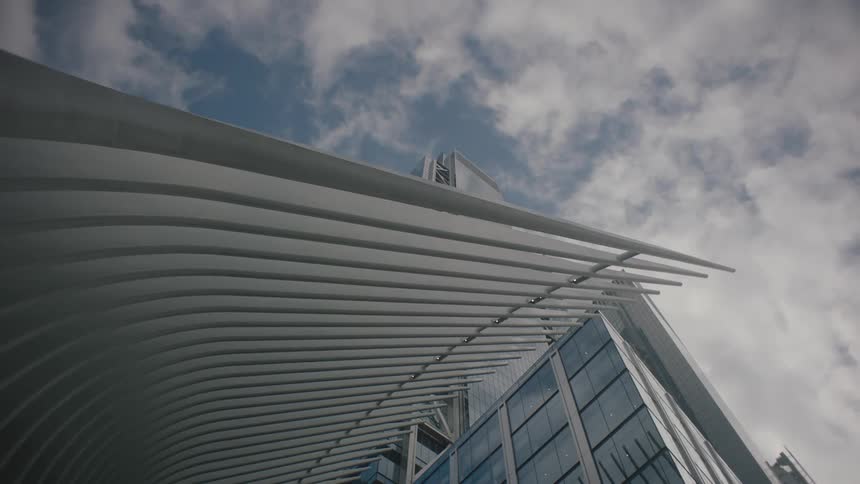 Clouds pass over building with an arched ribbed structured
