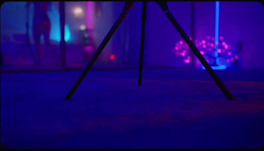 A woman moves her tripod across the room