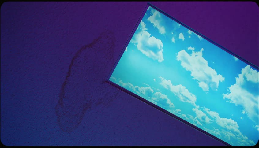 Television on the wall with an image of clouds