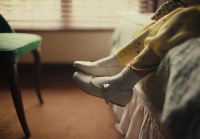 A child is sitting on the bed