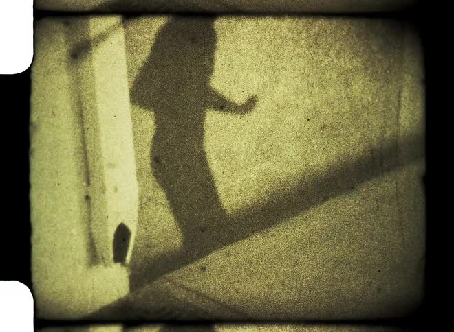 Shadow of a man dancing on a wall