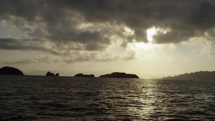 Waves rolling towards shore during a cloudy sunset