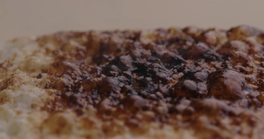 Closeup of a marshmallow bubbling and changing color while being roasted