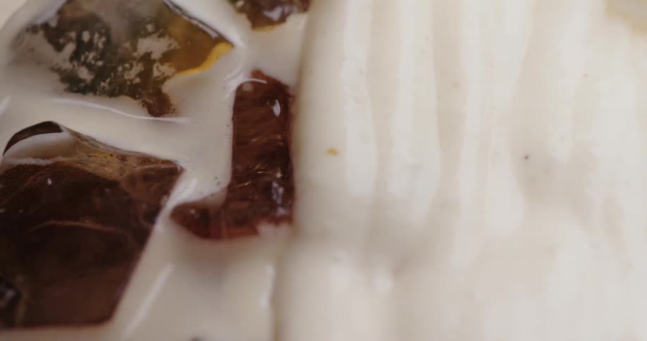 Cream being placed on a dessert with marshmallows