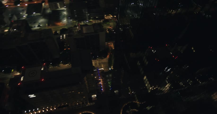 Panorama of a fully mirrored skyscraper in the middle of a bustling city