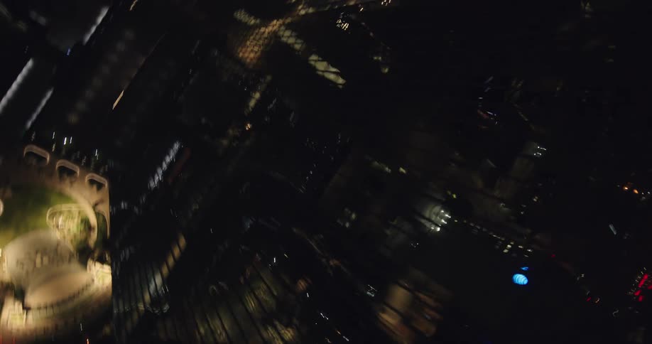 Dark skyscrapers towering over downtown street reflect cityscape at night