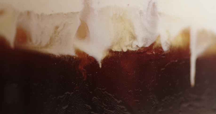 Blurry white cloudy substance over a brown background