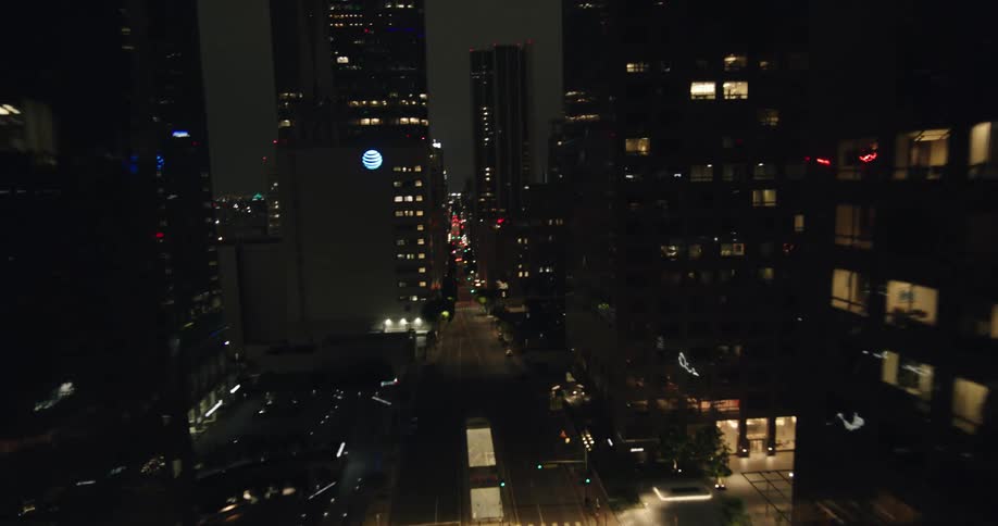 Aerial of the city with glass skyscrapers in the city illuminated at night