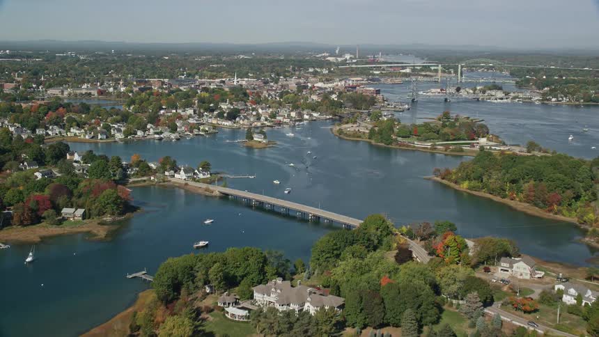 An aerial view of city suburbs on islands in the water with bridges and boats between them