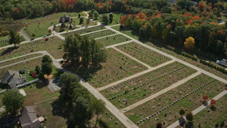 A cemetery with several tombstones in a residential area