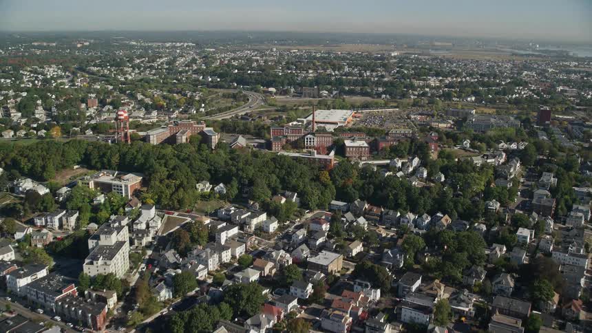 Aerial of trees and buildings in a metropolitan area at midday
