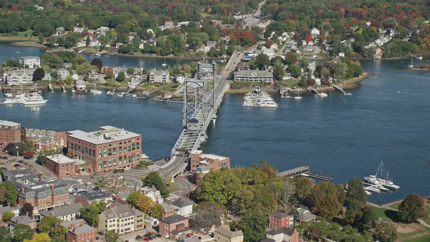 A huge bridge that passes over a river and connects to a city