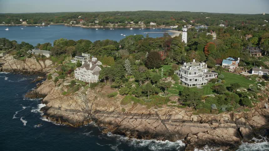 Aerial of mansions along a rocky coastline during autumn