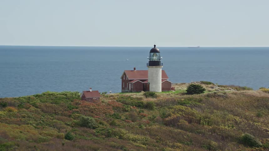 A lighthouse on a cliffside overlooking the ocean