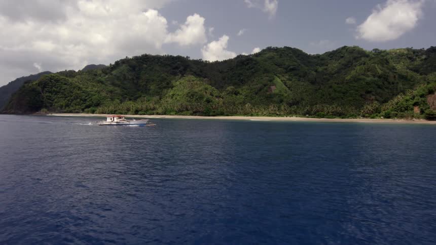 A boat is near the shore traveling