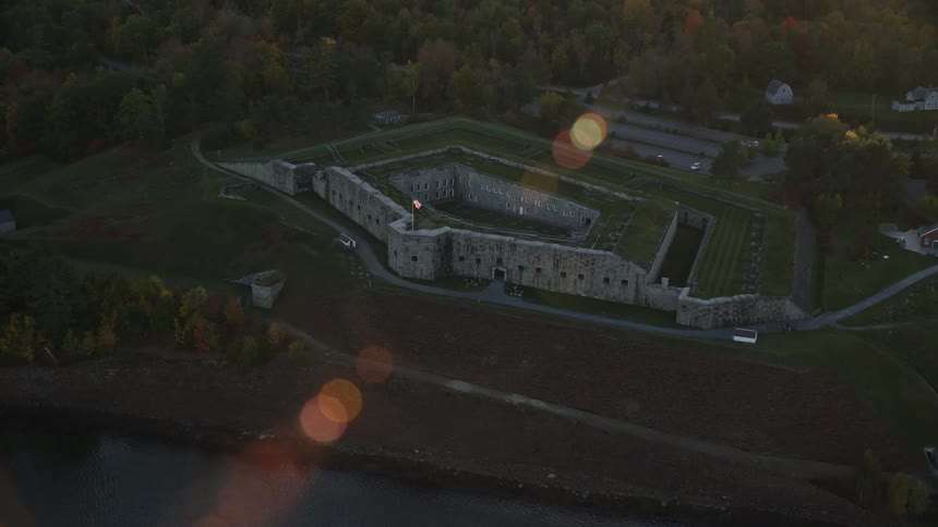 An aerial view of a castle beside the river