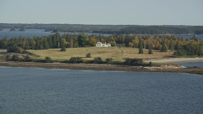An island with a building surrounded by trees