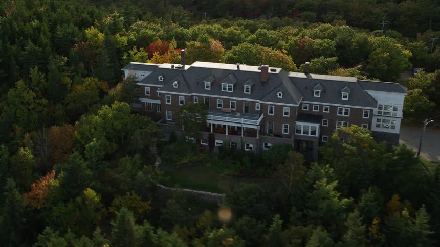 Aerial view of a large manor in the forest