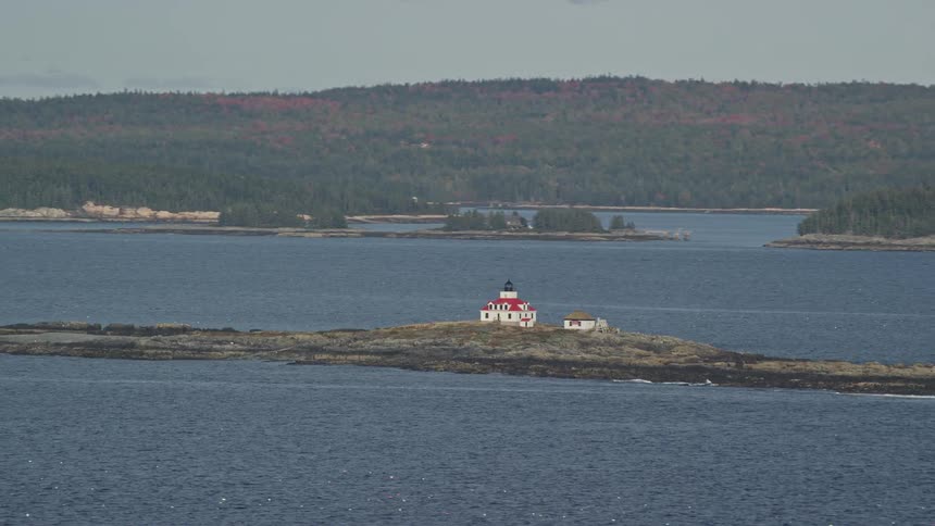 Aerial view of a small house built on an island on the lake