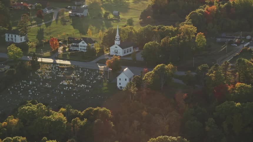 Aerial view of a church in front of a cemetery