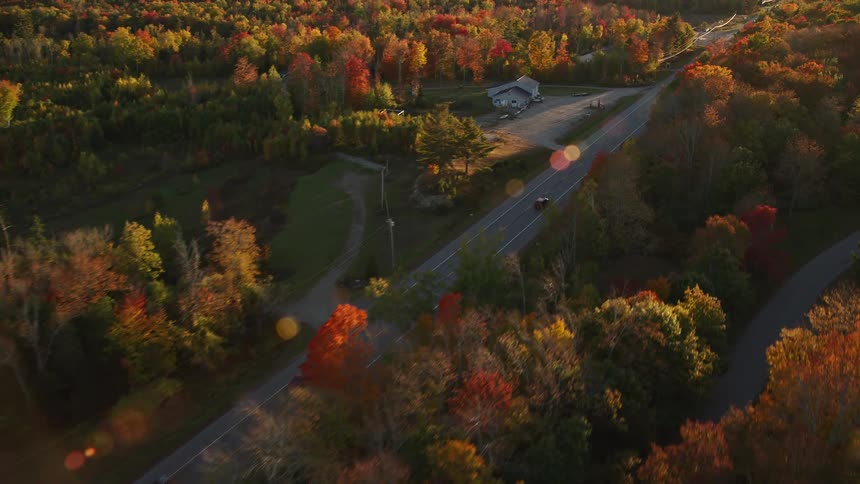 Aerial view of cars driving on a road through the countryside