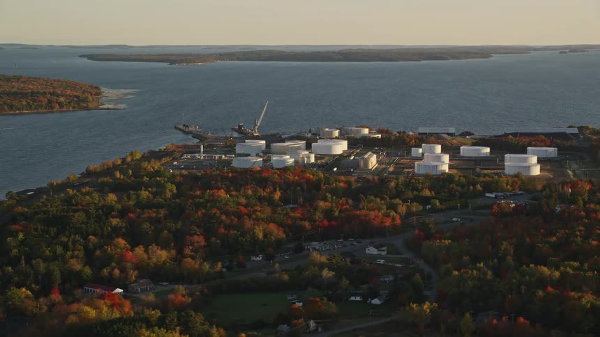 Aerial of a waterfront factory in a small residential neighborhood