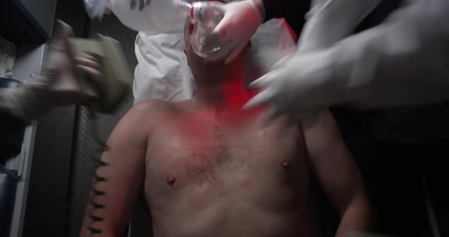 Several people perform cpr on a man